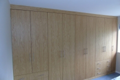 Full wall, floor to ceiling bespoke wardrobes with drawer units