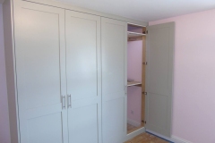 Floor to ceiling bespoke Shaker style wardrobes in light grey with short & long hanging rails