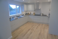 Extension fully decorated & fitted with grey gloss kitchen & laminated wooden floor